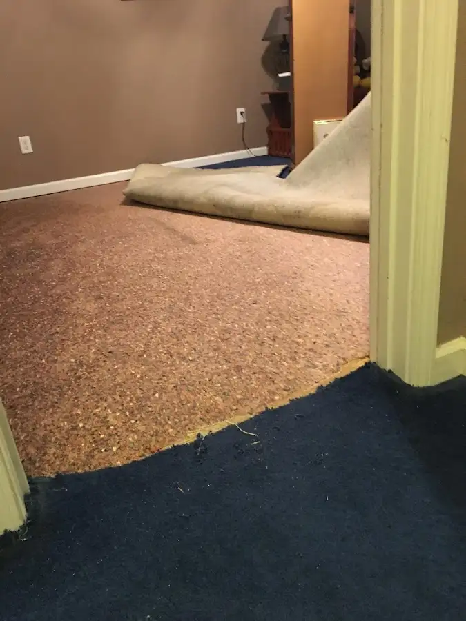 Carpet pad removal revealing water damage during Water Mitigation Services in Yorba Linda